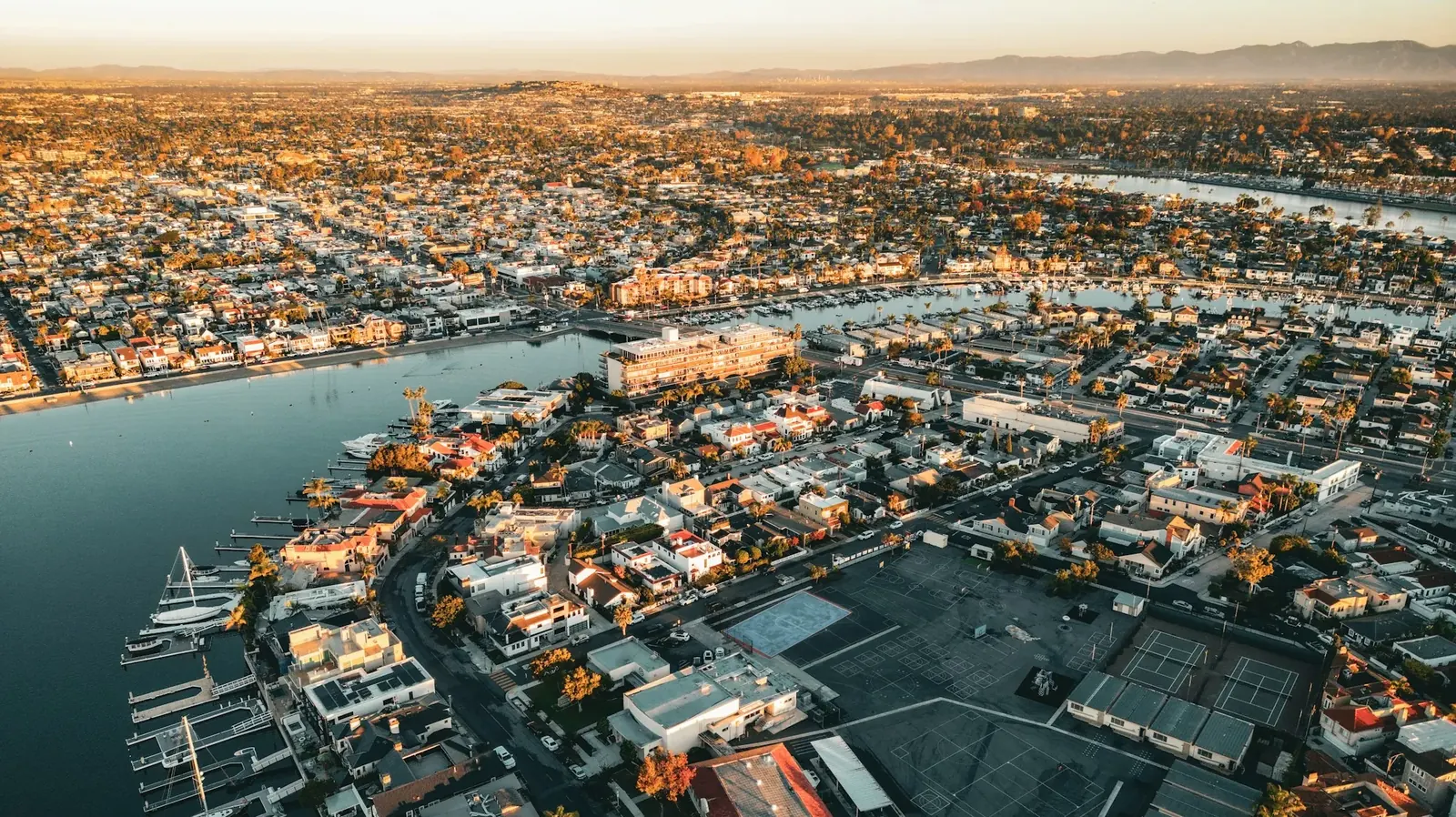 Aerial view of a coastal city and its neighborhoods at dusk