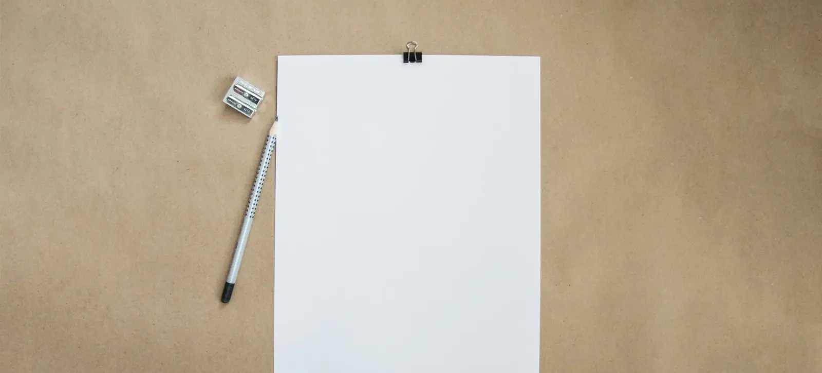 Blank sheet of paper and a pencil on a desk