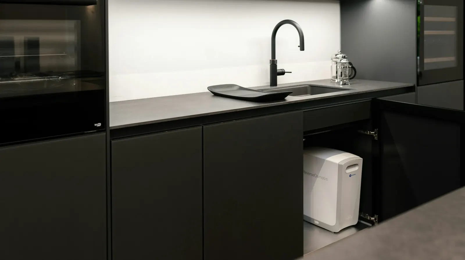 Dark kitchen with a compact filtration unit under the counter