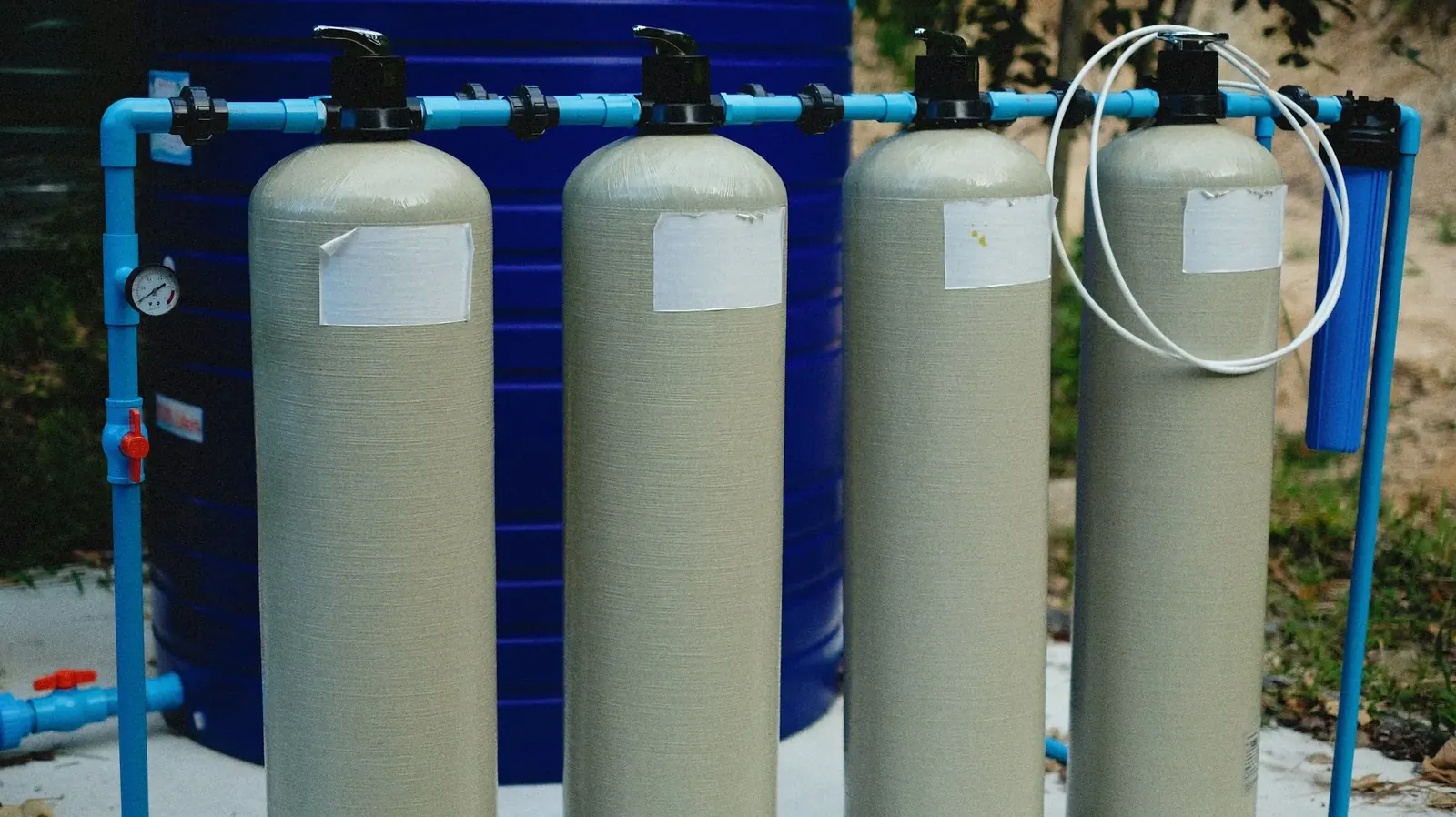 Water treatment tanks lined up in a utility space
