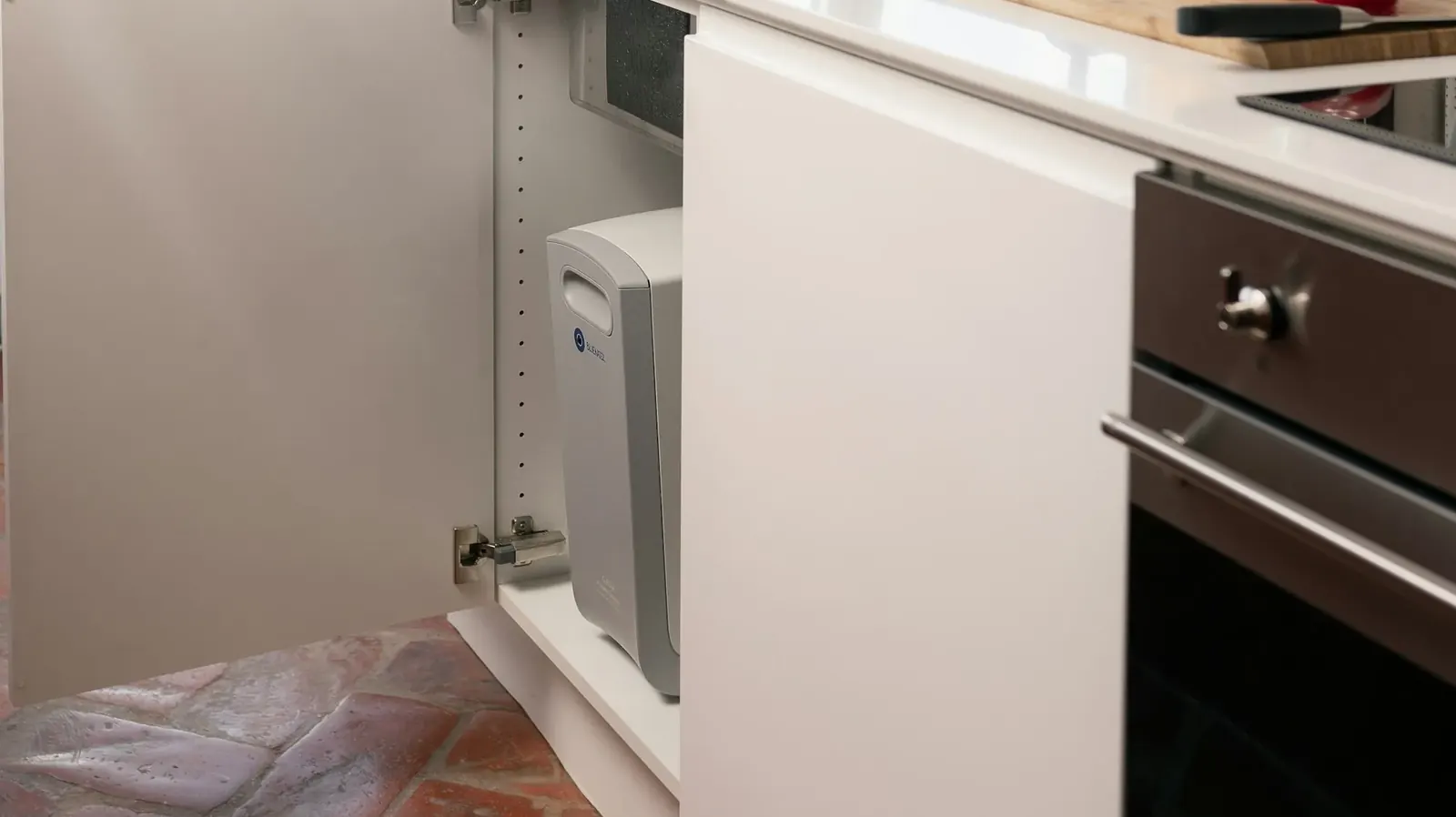 Bright kitchen with a filter unit in an open cabinet