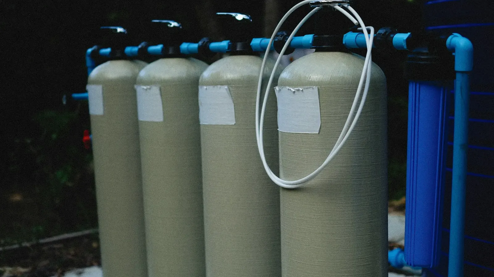 Water softener tanks with blue piping